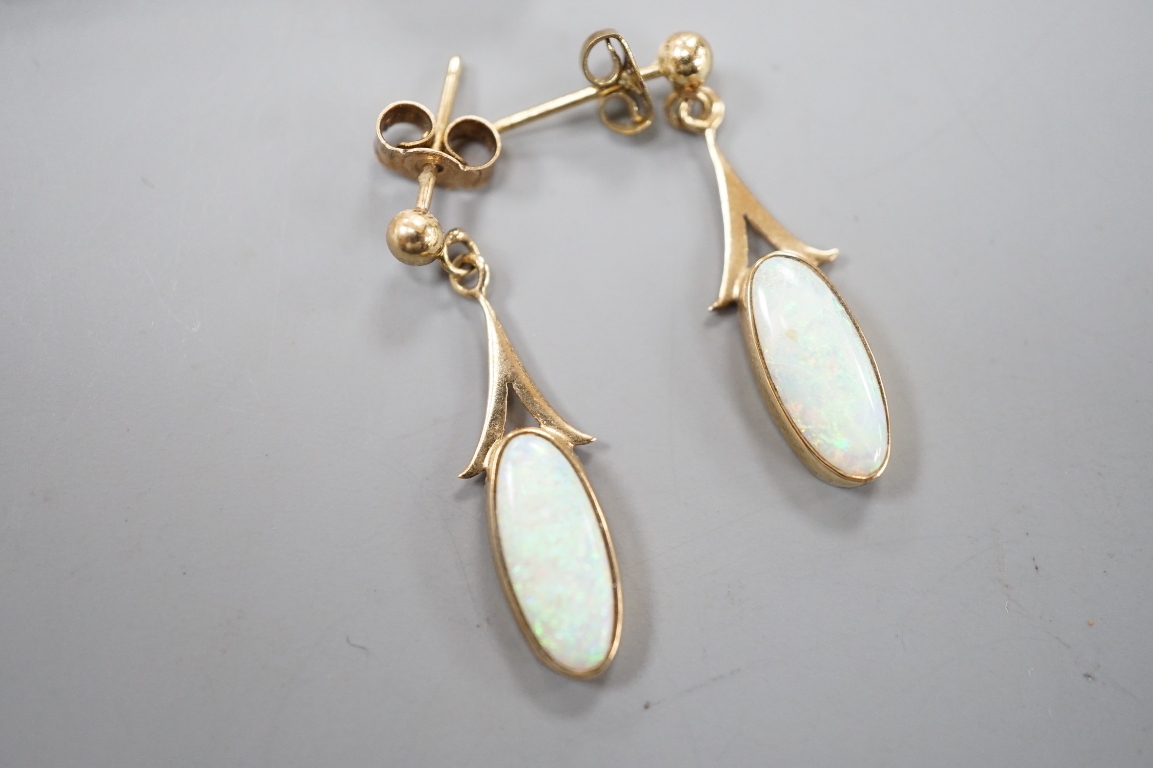 A 15ct and white opal set bar brooch, 60mm and a pair of yellow metal and white opal set drop earrings, gross weight 5.3 grams.